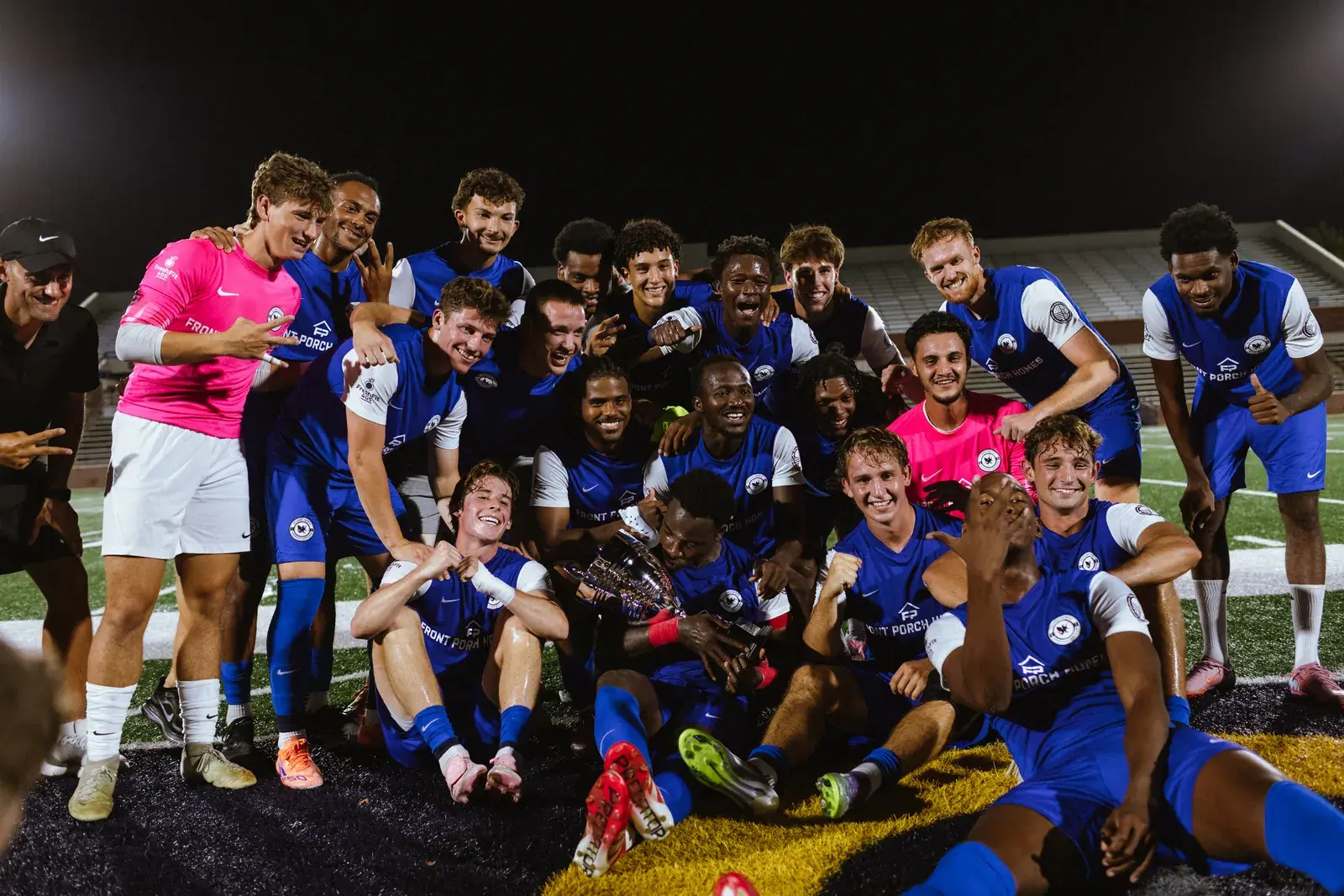 The Oklahoma United squad gathered on the pitch with the Central Regional Championship trophy